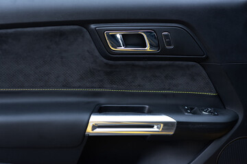 Sports car interior. Close-up Alcantara door trim. Detailing concept