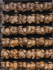 set of chikens roasting in a row