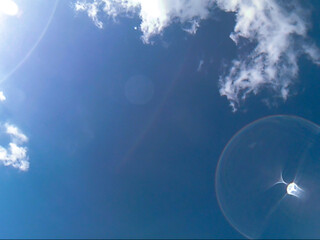 A view of the sky with clouds from under the water. Blurred background.