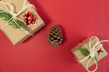 Big and small christmas gift boxes with pine cone, concept idea christmas photo, top view