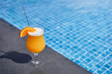 Relaxing weekend. The glass of cocktail on the poolside.