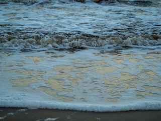 Fototapeta premium Wave with white foamy coastline beach. Sandy shore.