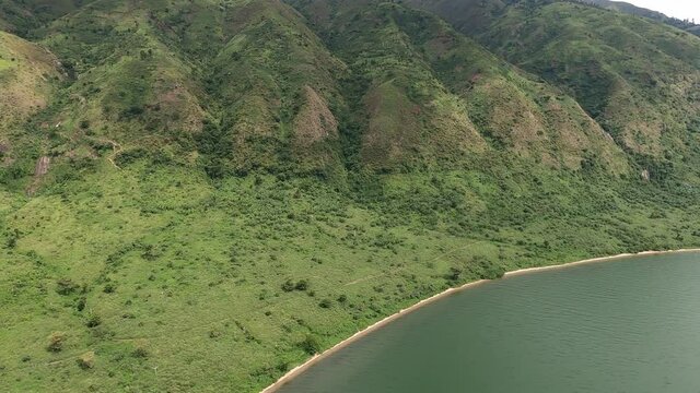 Green mountainous flight along western shore of Congo's Lake Edward
