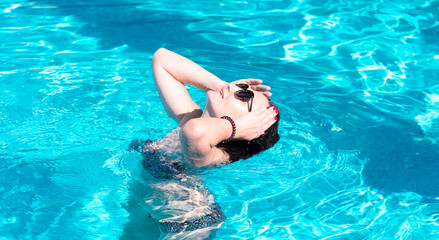 Sensual woman with wet hair enjoys and relaxes swimming in the pool. Seaside vacation, dacha6 trips