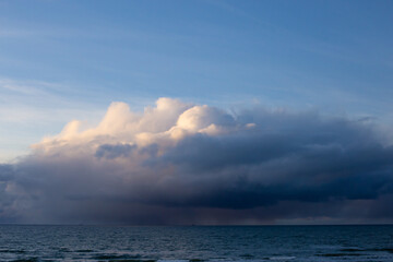 Fototapeta na wymiar Dramatic dark blue grey yellow stormy cloudy sky and evening winter Baltic sea background photo