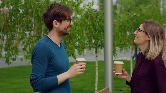 Smiling caucasian businesswoman and man Funny Coversation talking. Coworkers friendly discussion during lunch time. Happy Friends meeting.