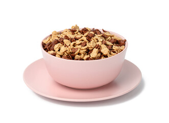 chocolate and honey cornflakes in pink plate on a white background. Morning breakfast with milk