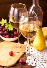 white wine and fruits. Wine and grapes in vintage setting on wooden table