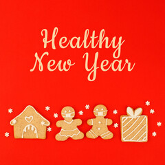 Fototapeta na wymiar Healthy New Year's Christmas set of ginger biscuits - man, gift box, house glazed sugar icing decoration on blue background, minimal seasonal winter holiday card, banner, flyer, coupon, stay home