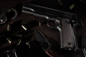 Weapons and military equipment. Handgun and knife on the table.