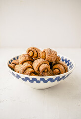 Homemade sweet pastry. Shortbread rolled cookies on light background. Russian traditional dessert rogaliki. 
