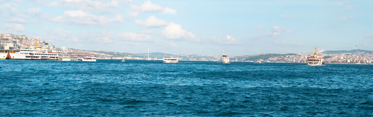 Fototapeta premium Large panoramic view of the Bosphorus strait with bridge, ships and architecture during sunny summer day in Istanbul, Turkey.