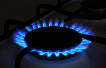 Natural Gas. High prices of natural gas. Blue flames of gas burning from a kitchen gas stove....