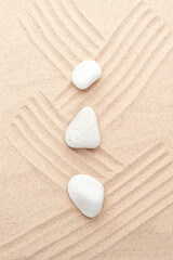 Fototapeta na wymiar White stones on the sand. Lines drawn on the sand. Top view