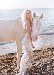 pretty young lady riding a horse on the beach in early morning