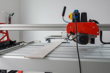 Cutter machine for ceramic tiles. A flat during renovation.
