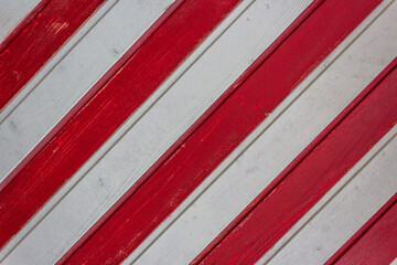 Board fence texture of white and red wooden boards arranged diagonally for web design. Wooden wall,...