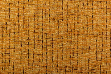 Factory fabric with brown and yellow threads interspersed. Close-up long and wide texture of natural fabric. Fabric texture of natural cotton or linen textile material.