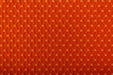Factory fabric of red color with yellow threads interspersed. Close-up long and wide texture of...