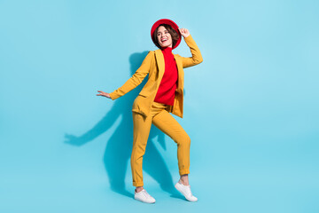 Full length body size view of attractive cheerful girl dancing having fun isolated over bright blue color background
