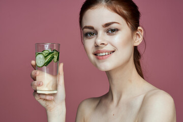 pretty woman with cucumber drink vitamins health beauty