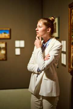 Woman visitor in the historical museum looking at pictures