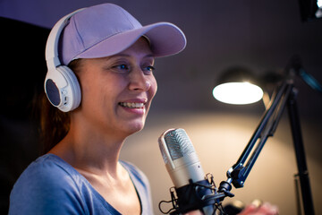 Beautiful Woman In A Cap And White Headphones Leads A Live Stream
