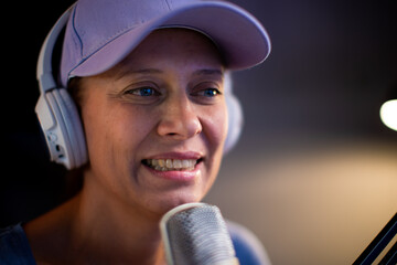 Beautiful Woman In A Cap And White Headphones Leads A Live Stream