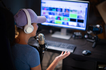 Beautiful Woman In A Cap And White Headphones Leads A Live Stream