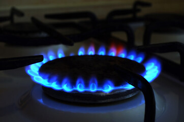 Natural Gas. High prices of natural gas. Blue flames of gas burning from a kitchen gas stove. Energy crisis.