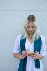 a professional young blonde woman using a smartphone. selfie