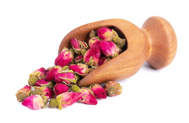 Heap of dry tea roses buds in wooden scoop, isolated on white background. Rose flower tea. Clipping...