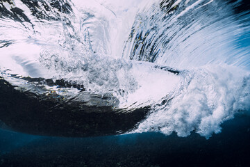 Transparent water and breaking barrel wave in underwater sea
