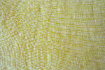 Light yellow natural linen fabric texture for backgrounds. Closeup  