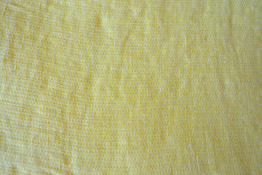 Light yellow natural linen fabric texture for backgrounds. Closeup  