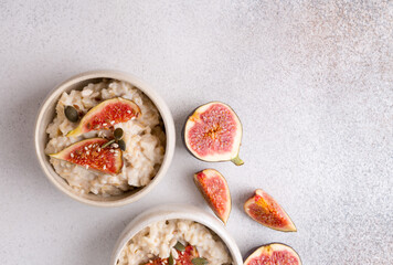 Oatmeal porridge with figs and seeds. Healthy breakfast food.