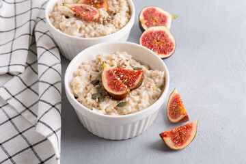 Oatmeal porridge with figs and seeds. Healthy breakfast food.