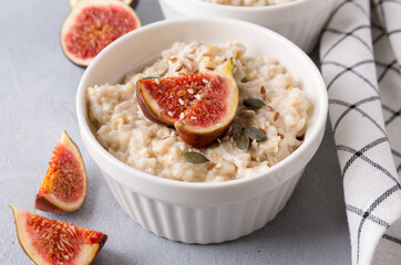 Oatmeal porridge with figs and seeds. Healthy breakfast food.