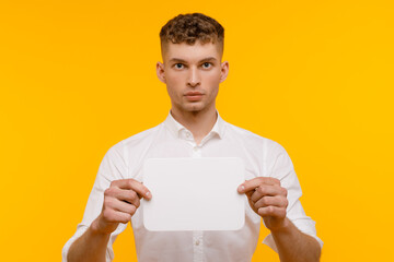 Young businessman is showing the word. Your text here