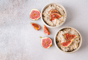 Oatmeal porridge with figs and seeds. Healthy breakfast food.