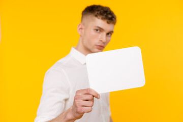 Young businessman is showing the word. Your text here