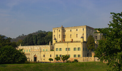 Fototapeta na wymiar Italian landscape. View of the Catajo castle, a 16th century building surrounded by greenery. Warm afternoon light.