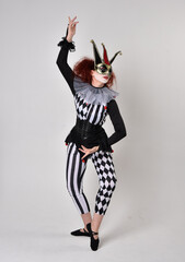   halloween, character, costume, figure pose, posing, portrait, gesture,  isolated,  magical, dynamic movement,  isolated,  studio background,  red hair, circus, theatre, jester, clown,  
full length,