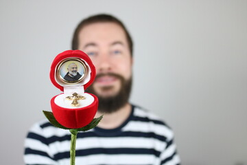 Man showing religious item with Padre Pio 