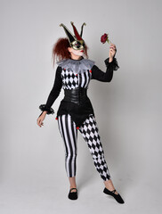   halloween, character, costume, figure pose, posing, portrait, gesture,  isolated,  magical, dynamic movement,  isolated,  studio background,  red hair, circus, theatre, jester, clown,  
full length,