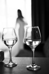 close up view of many glasses, partly blurred brides silhouette