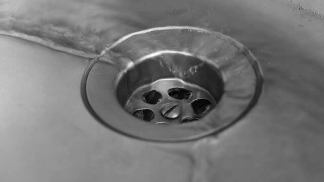 4k. The water from the sink is sinking into the sewer. Plumbing and household repair concept 