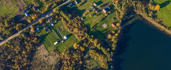 Top view autumn landscape with yellow trees on bank of lake. Nature concept.