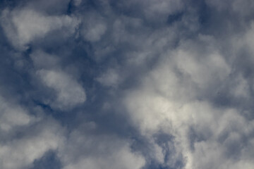 Beautiful dramatic, apocalyptic sky, cloud storm, pattern background. Sun rays through the clouds. Contrast sky. sunset