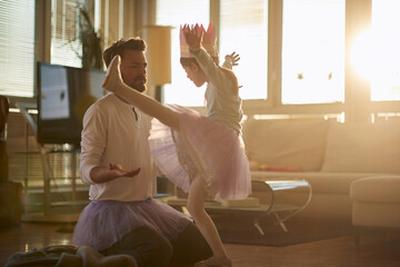 A young father is not satisfied with moves of his little ballerina while they have a ballet training at home. Family, ballet, training